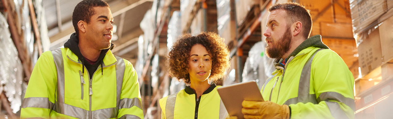 Tablet showing the Think Droid warehouse system, woman in high-vis vest holding a clipboard