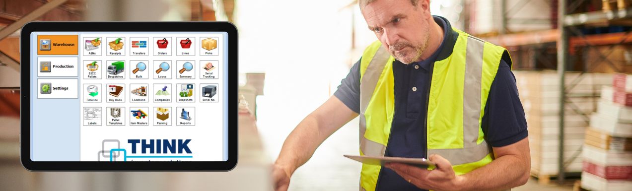 Tablet showing the Think warehouse system, man in high-vis vest working in the background