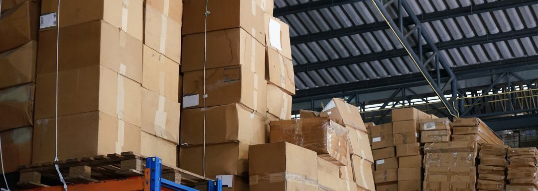 Cardboard boxes piled high in a warehouse