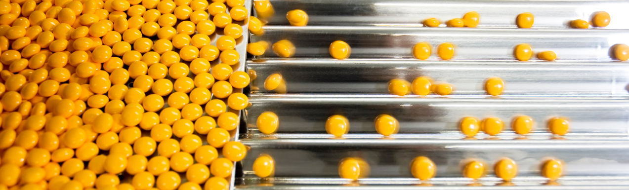 Yellow tablets being sorted in a factory